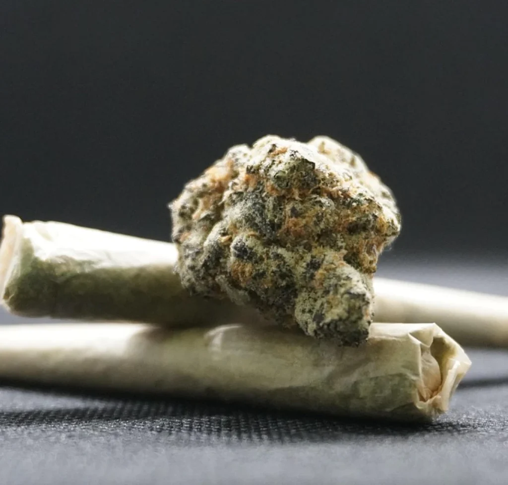 Marijuana bud and rolled joints, representing a minor marijuana possession charge under 2 ounces
