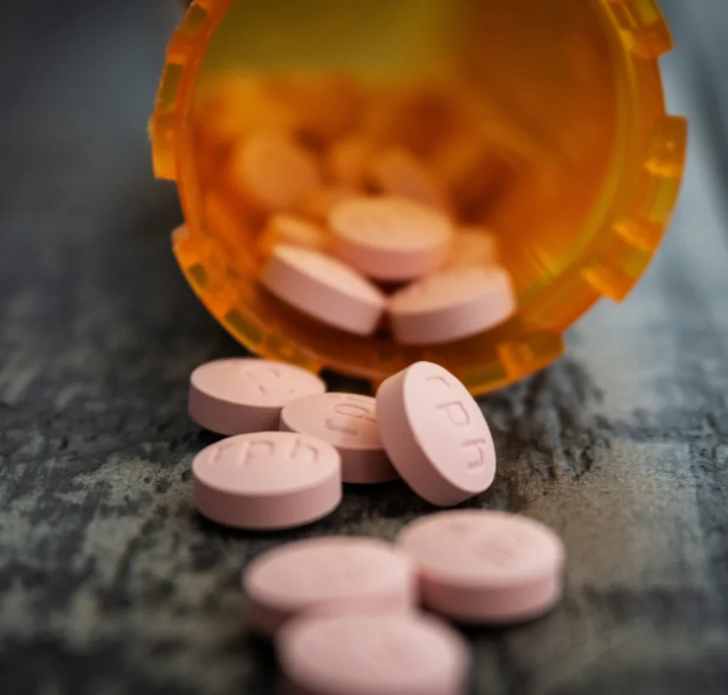Spilled prescription pill bottle, representing a controlled substance possession charge